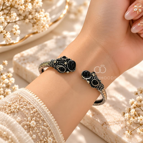 Black and silver-tone adjustable cuff bracelet with ornate detailing and round black accents | SISTERHOODS-SHA256:d64a507d096b3d31580bf101a50534549ca039a6c84d5ac7bcf8f0027e800fa2