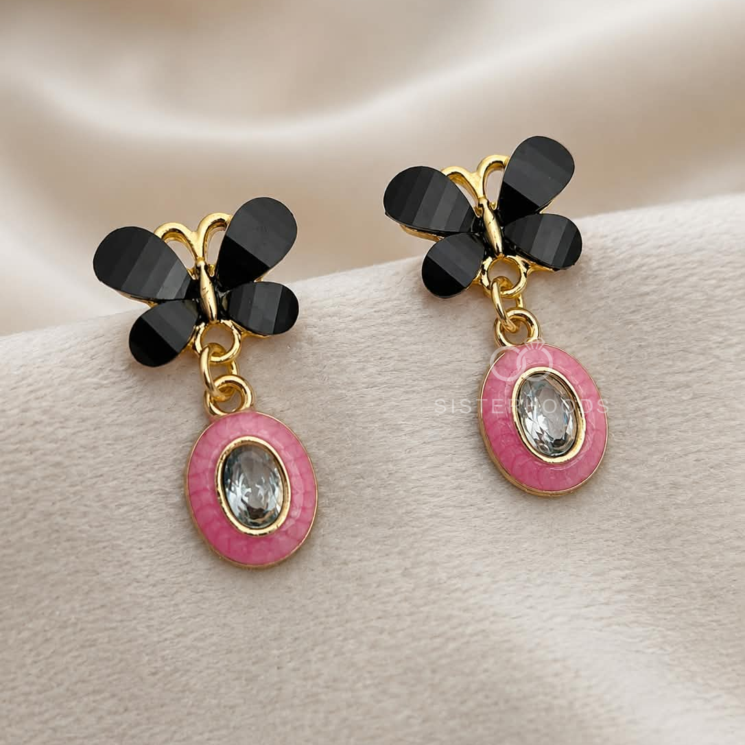 Black butterfly-inspired earrings with pink oval drops and clear faceted centre accents | SISTERHOODS-SHA256:010322007d33e74617803a5089a5e77a3dd7fabbf251ff871ababe13dd7894f5