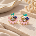 Multicolour floral stud earrings with pink petals, teal leaves, navy accents, white beads and sparkling centres | SISTERHOODS-SHA256:f52b80b5afc43c3aec4ad3718a9316dccc3f67fcd1957b3fffaffe4b3287a750