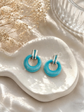Turquoise textured hoop earrings with silver-tone details | SISTERHOODS-SHA256:e5185c93975f0281874d31032b88bb30f28c29d12ceb327d88ab23a6f55af87a