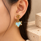 Gold-colour heart dangle earrings with multicolour centres, rose-shaped tops and star accents | SISTERHOODS-SHA256:9a325eeebbfff86141ffd9a586f0873ba456e1118bda5709aed8937c0213f2df