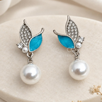 Silver-tone dangle earrings with blue leaf accents, clear embellishments and white round drops | SISTERHOODS-SHA256:07f6cad8867ef0152d3349908e6d75f503148a21d4e0c19d430f2753c0631f3a