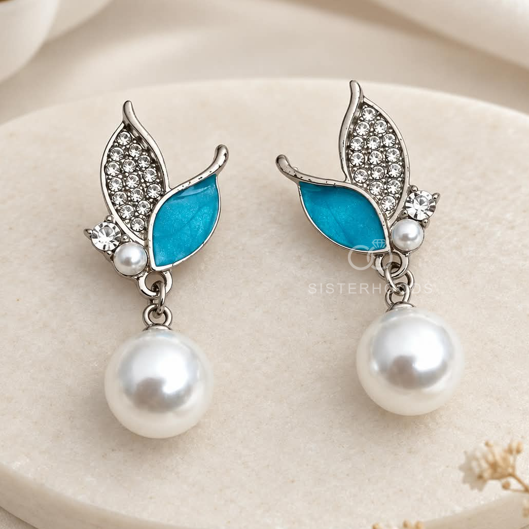 Silver-tone dangle earrings with blue leaf accents, clear embellishments and white round drops | SISTERHOODS-SHA256:07f6cad8867ef0152d3349908e6d75f503148a21d4e0c19d430f2753c0631f3a