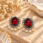 Oxidized dangle earrings with red oval centres, pearl drops and circular detailing | SISTERHOODS-SHA256:4cba5ec2c414607312de981ca3f9a7c508c54a524112e40e4f323ecce3eb2564