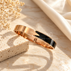 Gold-tone cuff bracelet with glossy black accent and Love detail | SISTERHOODS-SHA256:5ab45e854260c27684f2ed16d100f8aec1ba707ad54833a4e24b4fdb08a6a208