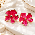 Pink floral stud earrings with gold-tone borders and round centre accents | SISTERHOODS-SHA256:8fca94bdb484238c2253776f2d139ae214a49f9bb844a6f6b5c6acc6e549edb4