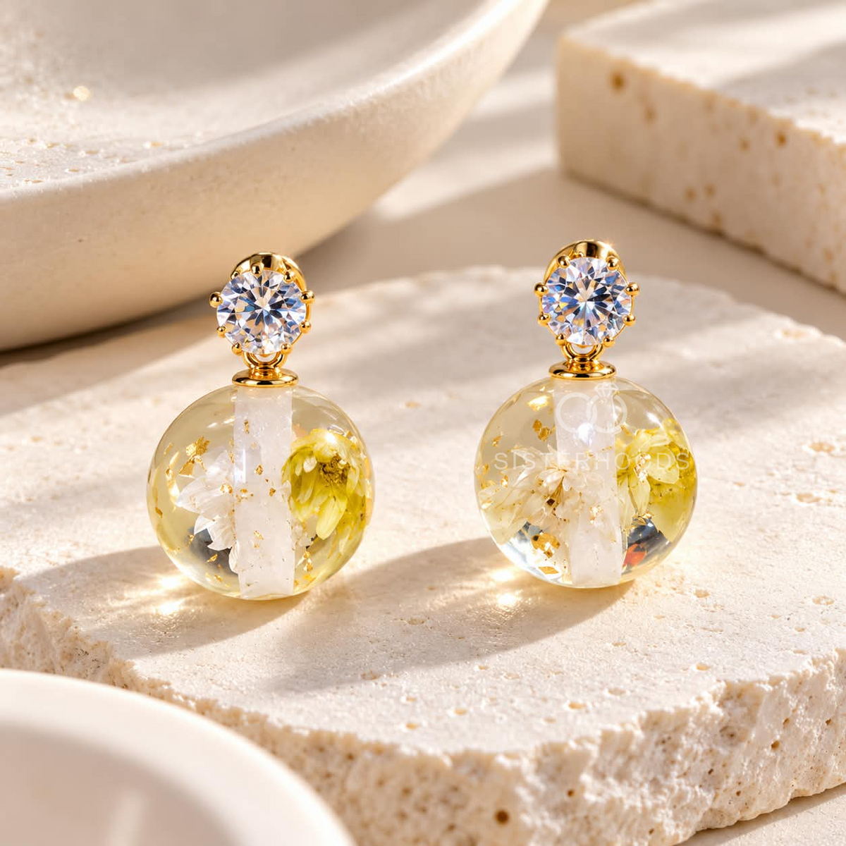 Round clear floral drop earrings with gold accents and sparkling stud tops | SISTERHOODS-SHA256:333070ec886a0e11f47d66956028c863f5403c1e561a3e60482753a6c202e2ff