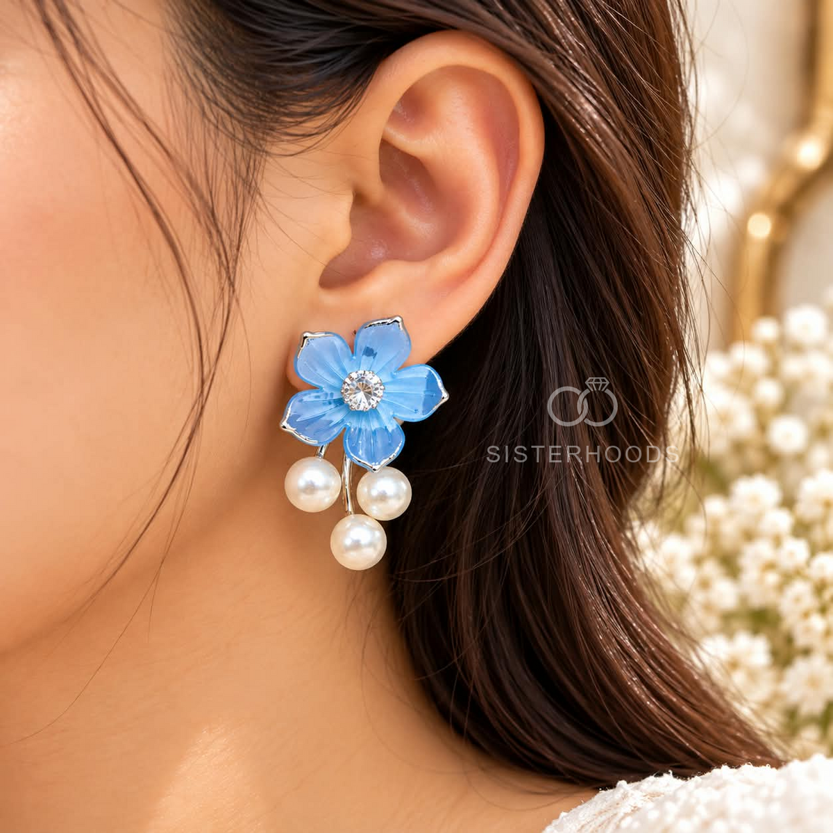 Blue floral dangle earrings with sparkling centre accents and three white pearl drops. | SISTERHOODS-SHA256:cdff9f4d1a090687e5373db2fcf192128cc9d5d9cd280c66a54d677abc8195b2