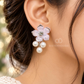 Pink flower earrings with a sparkling centre and three dangling white pearls | SISTERHOODS-SHA256:5fa1eda1b3b90a07b25e9bb34d0d238b8976ba4fe608873722b62ffc240495a0