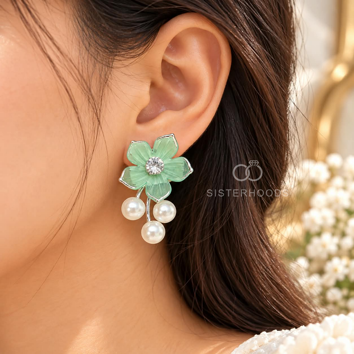 Green floral dangle earrings with a sparkling centre and three white pearl drops | SISTERHOODS-SHA256:c4d3a24355ff7375eeec3df0d560949fc18fb7d43eb4de94824584714b981098