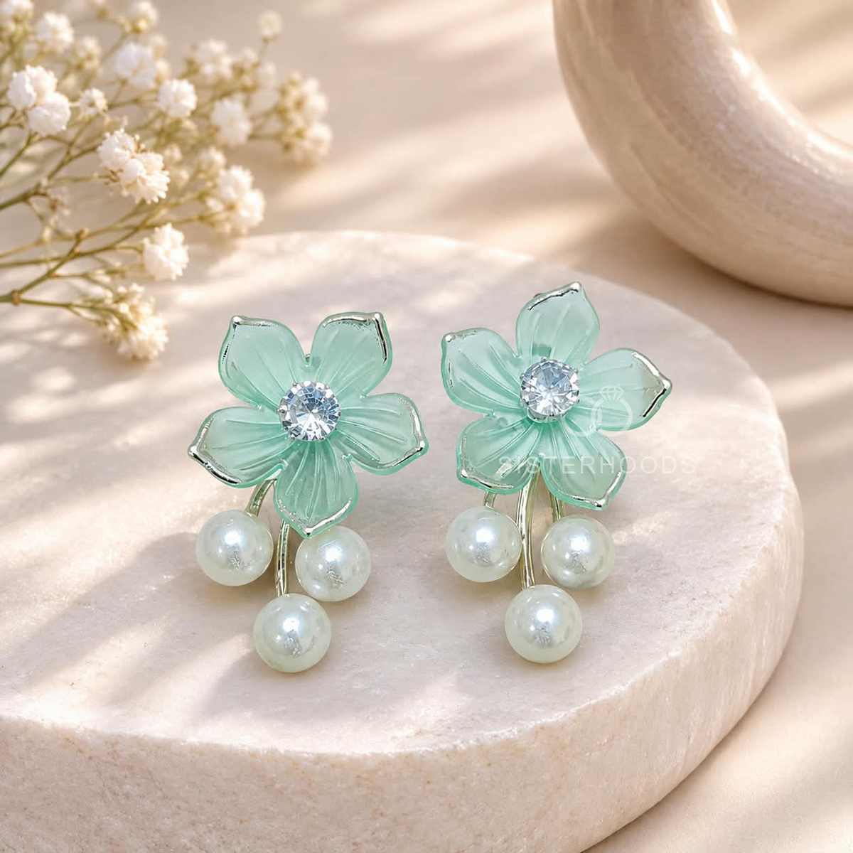 Green floral dangle earrings with a sparkling centre and three white pearl drops | SISTERHOODS-SHA256:5daf9c13a7e9e4e0ccc97ef9147fd4b0133af2fcdd73bd95a99507286c445705