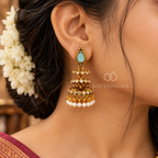 Gold-toned jhumka earrings with blue teardrop accents, clear stones and white bead fringes | SISTERHOODS-SHA256:009b7ceacccb6cf0de457b1cec17d49629317ef9d1f3828f0b2f5a9c3be1138e