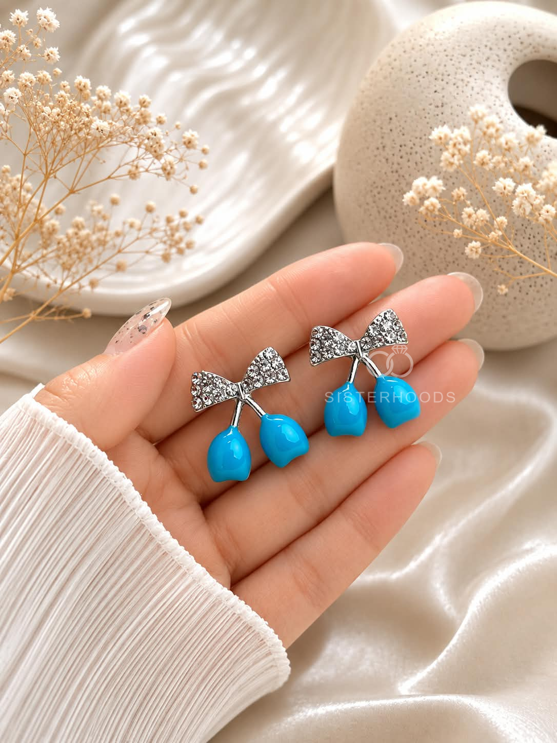 Blue drop earrings with textured bow-shaped accents | SISTERHOODS-SHA256:dc87ed944737078e8e2d0f520f6b8b1cbd7c9cc657b77cb794401cc30bffea50