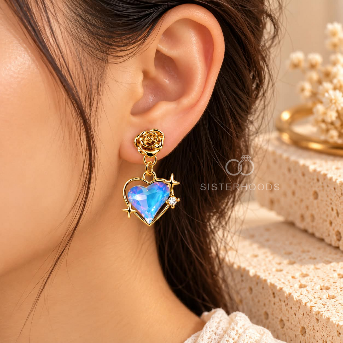 Gold-tone dangle earrings with blue iridescent heart charms, rose studs and star accents | SISTERHOODS-SHA256:d1050655456f228628c6f2b3e6334b77f68886a32d6b0e18fb7772a36b8ab2a6