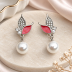 Silver-tone butterfly-inspired drop earrings with pink petals, sparkling accents and white bead drops | SISTERHOODS-SHA256:3dc3e7521c80340f1f78df5efc65487463ba3d859dff45ea326fd4d304f1a8ab