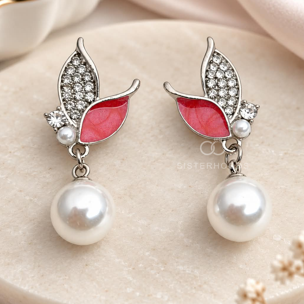 Silver-tone butterfly-inspired drop earrings with pink petals, sparkling accents and white bead drops | SISTERHOODS-SHA256:e5920894a30ce6151c670520c9cd02a2b7311725c87c07c8c71bfee75a262def