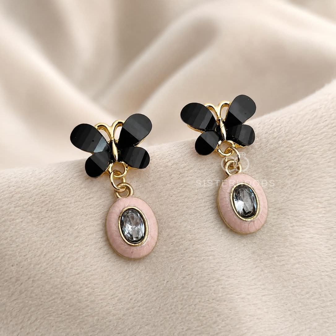 Black butterfly earrings with blush oval faceted drop accents | SISTERHOODS-SHA256:c6a381c7bcb1df09d872098514ac3f64432fed25992a74a27c8dbc2ff3b18310