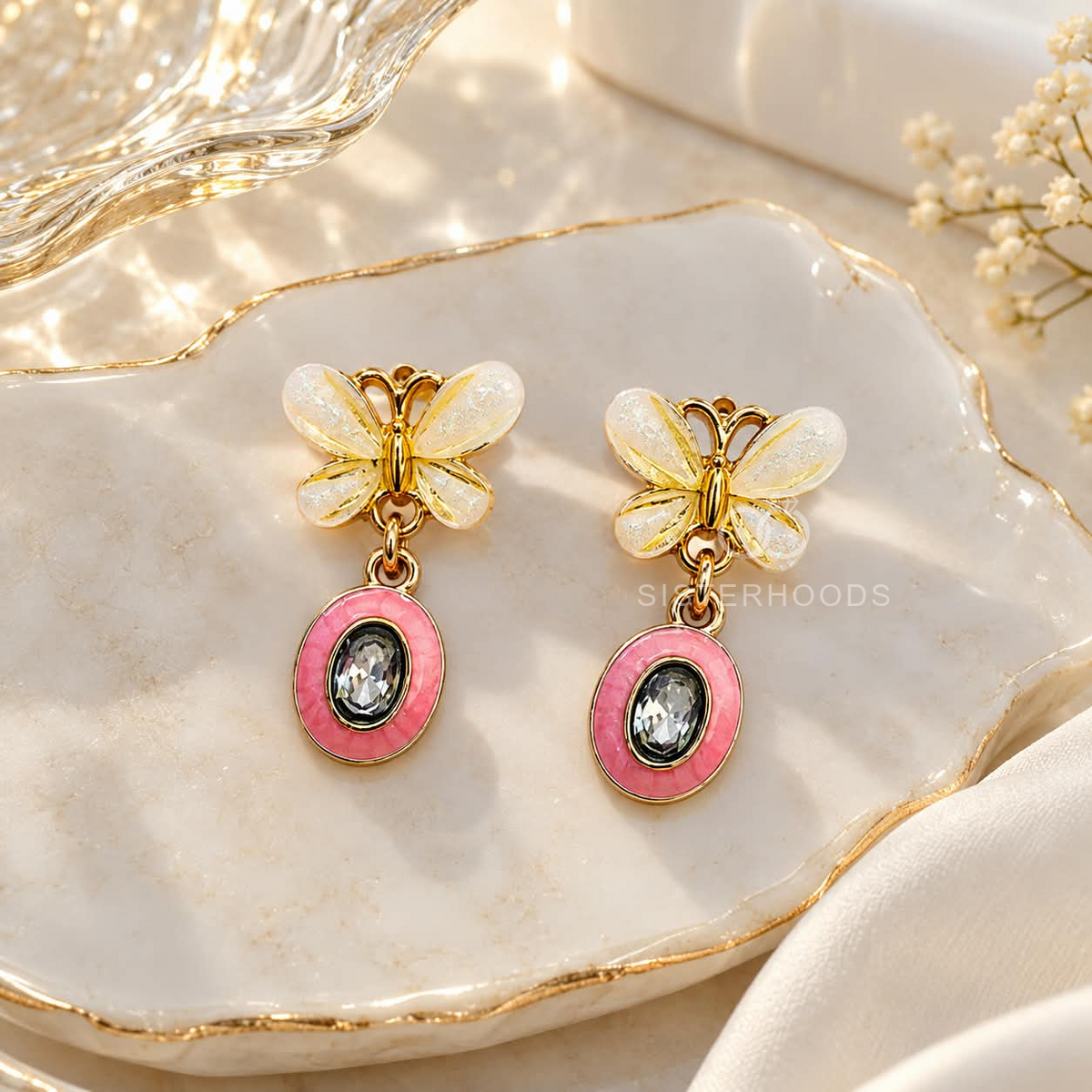 Butterfly Korean drop earrings with white wings, pink oval accents and dark sparkling centres | SISTERHOODS-SHA256:739f1080da94ba071976eb2aa489a03ce85d8462b60beb1985c136060220b757
