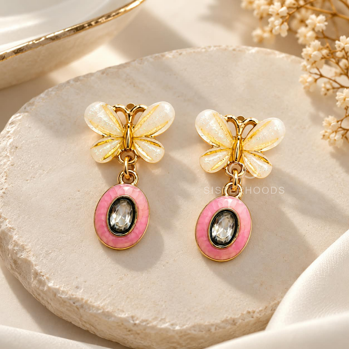 Butterfly Korean drop earrings with white wings, pink oval accents and dark sparkling centres | SISTERHOODS-SHA256:6c35e20abb90094cd5de9ed316bb9787de18741c487d3250249f79b4eeb6b821