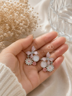 Silver butterfly and flower drop earrings with pink and white details | SISTERHOODS-SHA256:383e8da62fec5596432e3030a3e8e8a990e1b4c9d800e20dbdf6204ecfa7b75d