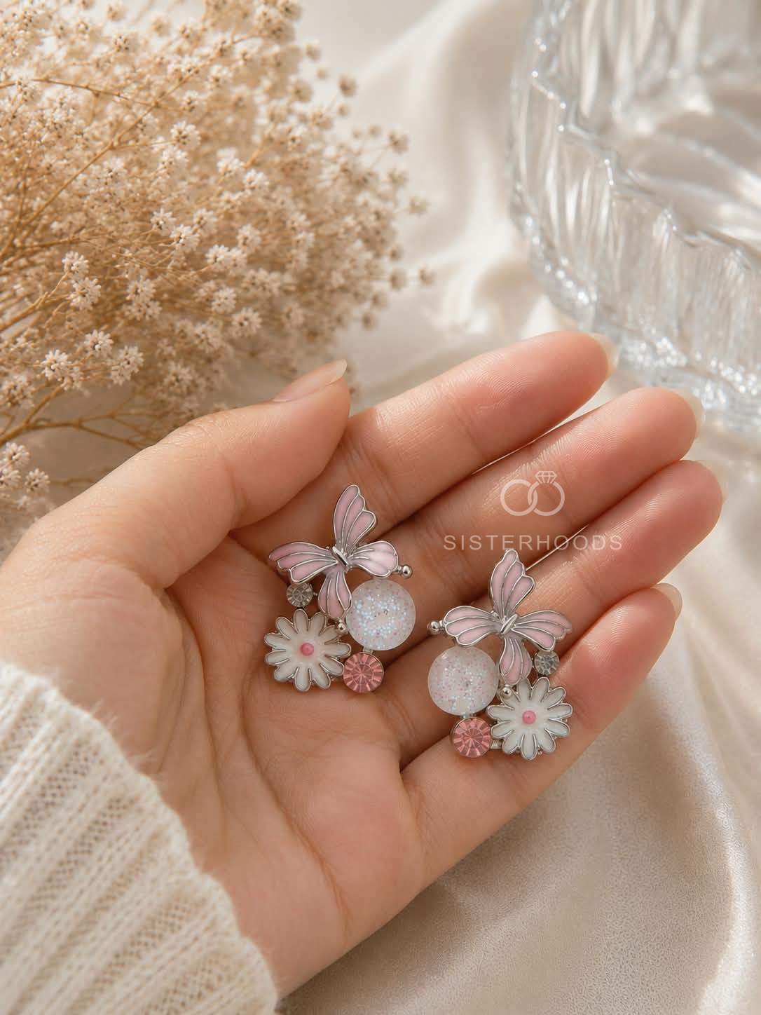 Silver butterfly and flower drop earrings with pink and white details | SISTERHOODS-SHA256:383e8da62fec5596432e3030a3e8e8a990e1b4c9d800e20dbdf6204ecfa7b75d