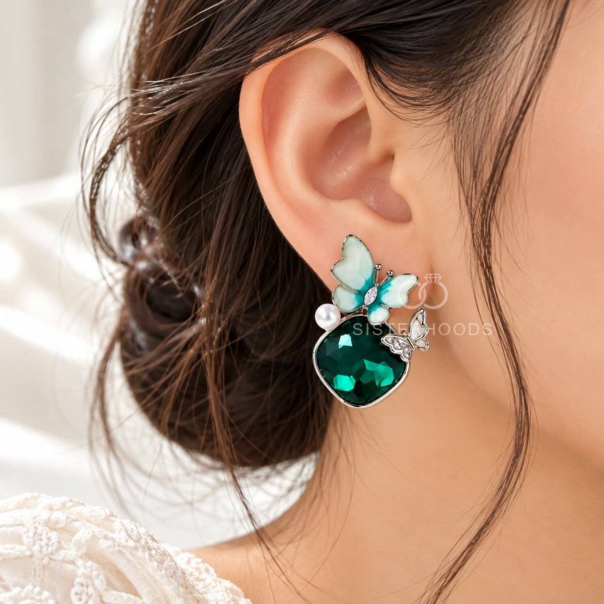 Teal butterfly dangle earrings with faceted green oval accents and white details | SISTERHOODS-SHA256:36893f02052cb11cd8acc5d2acb48fbbb02b5834e460efd7dc6fae6ca652de35