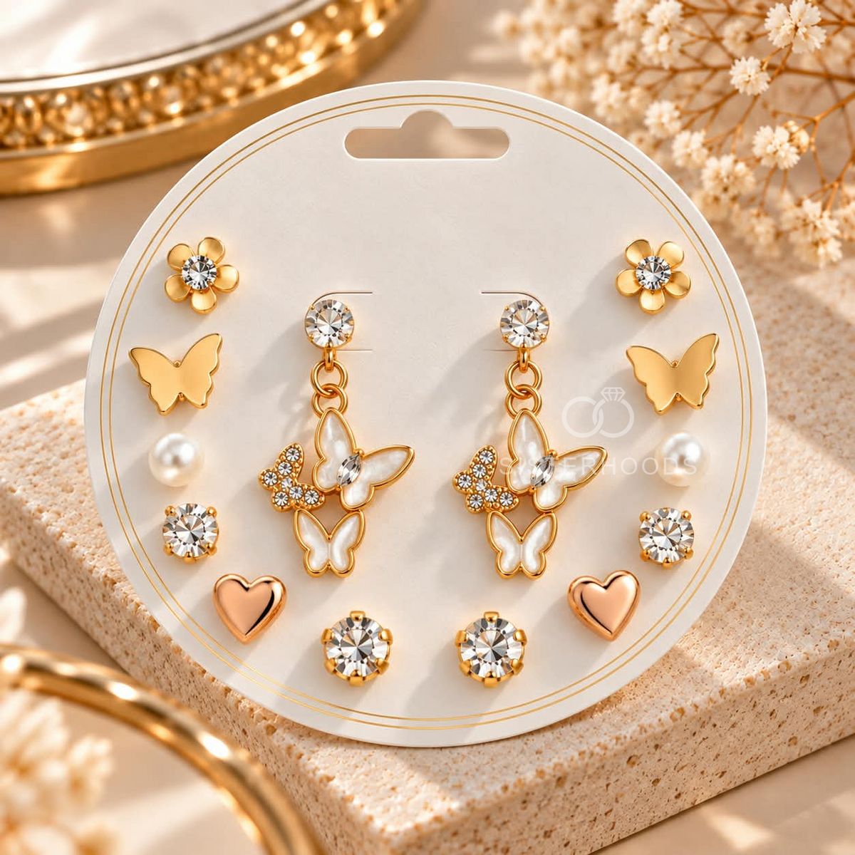 Mixed earring set with butterfly, floral, pearl, heart and sparkling stud designs on a display card. | SISTERHOODS-SHA256:0cddeb5de8252bb2d72d03f9eb75db7f05fa6f5e5b54331df0e7f53d0b6b8704