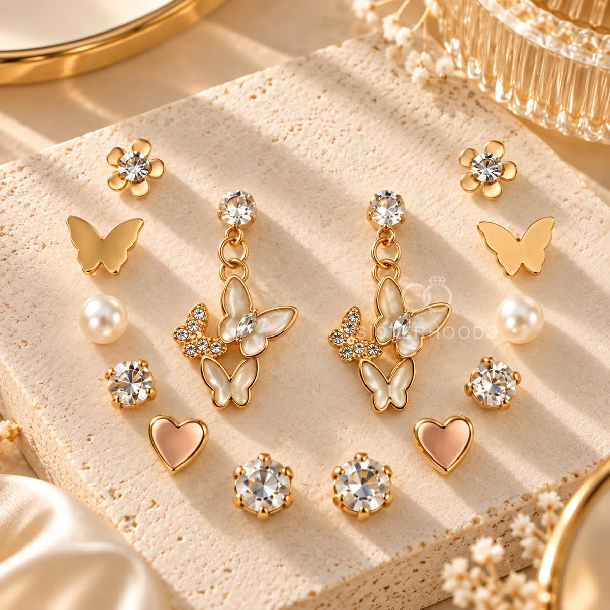Mixed earring set with butterfly, floral, pearl, heart and sparkling stud designs on a display card. | SISTERHOODS-SHA256:db395109d53d69465bb5cc6c103b51482b16eb9578b37ef522e9ea8c848c6d15