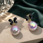 Black butterfly earrings with pink iridescent pearl drop accents | SISTERHOODS-SHA256:55d32df95dccde780a684618b3f3048701910e810fa7e76ddf9b02f244bf7359