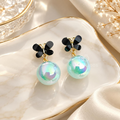 Black butterfly earrings with iridescent aqua round drops | SISTERHOODS-SHA256:1eff75543894e1b567c20c082360d599cbd687013e363a3434c548ca573480d6