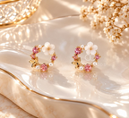 Round floral stud earrings with pink accents, white flower detail, delicate beads and butterfly motifs. | SISTERHOODS-SHA256:cc15b518cd678d6d3adbf023b57b8cbd18bf8d7ffb9c3232cb966eaa9400ede0