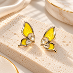 Yellow butterfly stud earrings with faceted clear accents and golden detailing | SISTERHOODS-SHA256:2c0f6305855536f6b51882e4454f8cfef763fad4d789f044db16715404419bc1