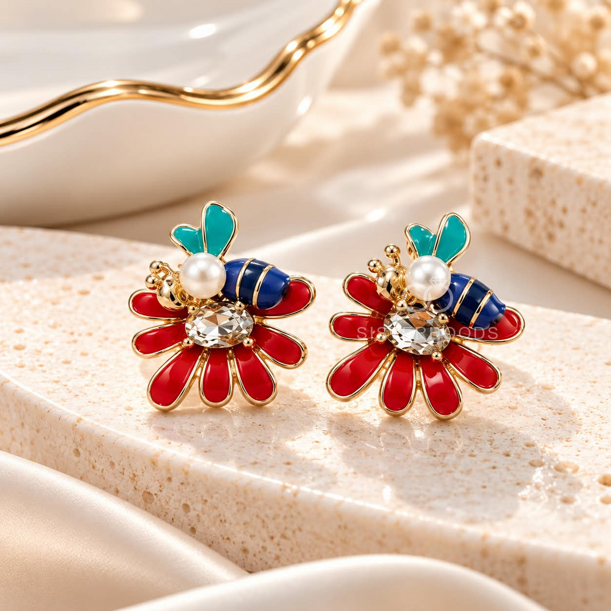 Multicolour floral stud earrings with red petals, blue and turquoise accents, pearl details, and gold-tone outlines | SISTERHOODS-SHA256:f52c29b5f3fb95fafb4650355c924a6da7544c8464f5298779378411f9b36f2e