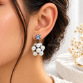 White pearl cluster dangle earring with a blue faceted stud accent | SISTERHOODS-SHA256:fd859fbeef1c9c51f2add9fe02238807255a3bfeedb2cdfb406df860d0e261e1