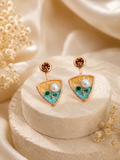 Multicolour triangular drop earrings with round stud tops and white, green and teal accents | SISTERHOODS-SHA256:e1f307043fd1f1ed8ba32bb4e661cb6ec19064451b9a7667aadde53af6c42890