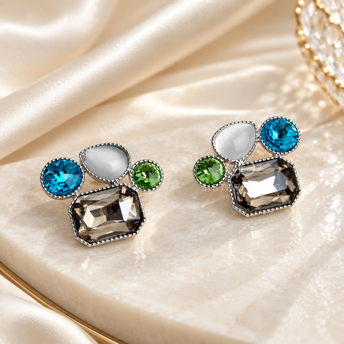 Multicolour geometric stud earrings with blue, green, clear and smoky faceted accents in silver-coloured frames. | SISTERHOODS-SHA256:8e6d15dc17f6226416a2699a6f8d22ce0daa664392e3295232ba81b4199ac7e9