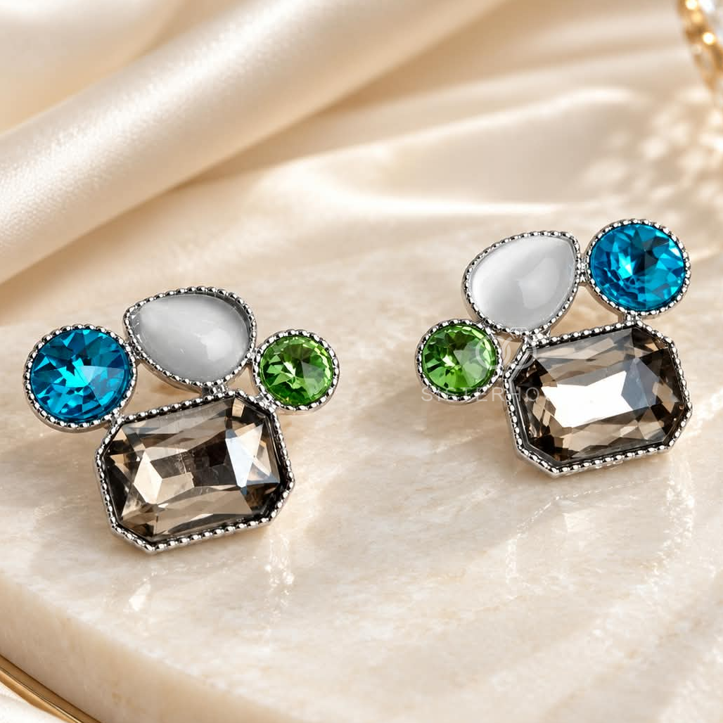 Multicolour geometric stud earrings with blue, green, clear and smoky faceted accents in silver-coloured frames. | SISTERHOODS-SHA256:2f53930851b80cb28a8d439e3e25d0782398128cb8461a2ddf227ff2aaa7a28c