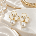 White four-petal floral earrings with crystal centres, gold-tone outlines and large pearl drops | SISTERHOODS-SHA256:9d148744dcae61fd66ab0bb5b0e57b0e1577f10450d81d1860ec1705173cd346