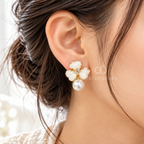White four-petal floral earrings with crystal centres, gold-tone outlines and large pearl drops | SISTERHOODS-SHA256:2ce0d82b67857917b9a727cee6191260c894e659821ba5e79e55178ad9feba8f