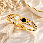 Gold-tone cuff bracelet with black and white circular accents and geometric openwork | SISTERHOODS-SHA256:357f7eb1d3b522223c1f989850faae6c1c8d100675488b9d72e646313bcc4eec