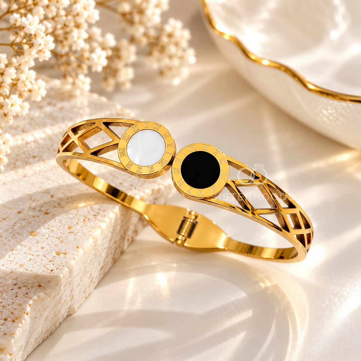 Gold-tone cuff bracelet with black and white circular accents and geometric openwork | SISTERHOODS-SHA256:357f7eb1d3b522223c1f989850faae6c1c8d100675488b9d72e646313bcc4eec