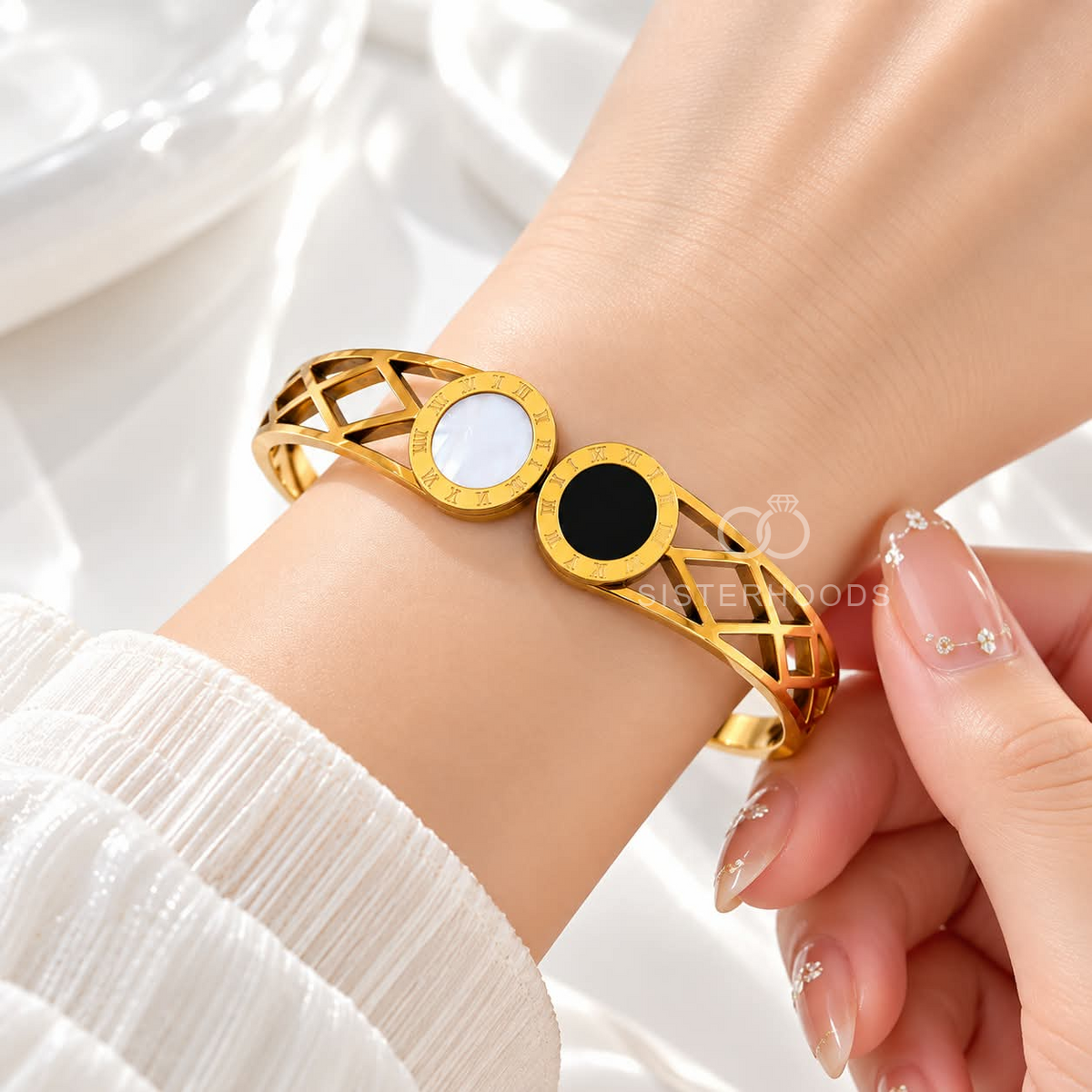 Gold-tone cuff bracelet with black and white circular accents and geometric openwork | SISTERHOODS-SHA256:f9237dba698b87b9d1171c2555e2002f7d6fc2181173cdae8dc3cd3dc69f18f7