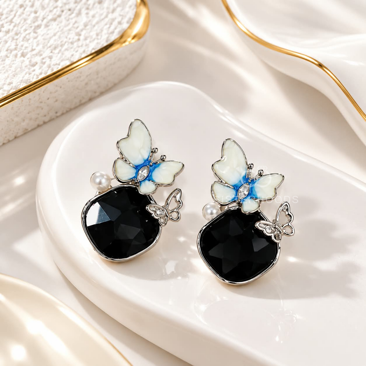 Blue-white butterfly dangle earrings with black faceted drops and pearl accents | SISTERHOODS-SHA256:82bc5b2470901d4be771800f484e9fe56e3170f385c0fea2ce4b55dd0a007350