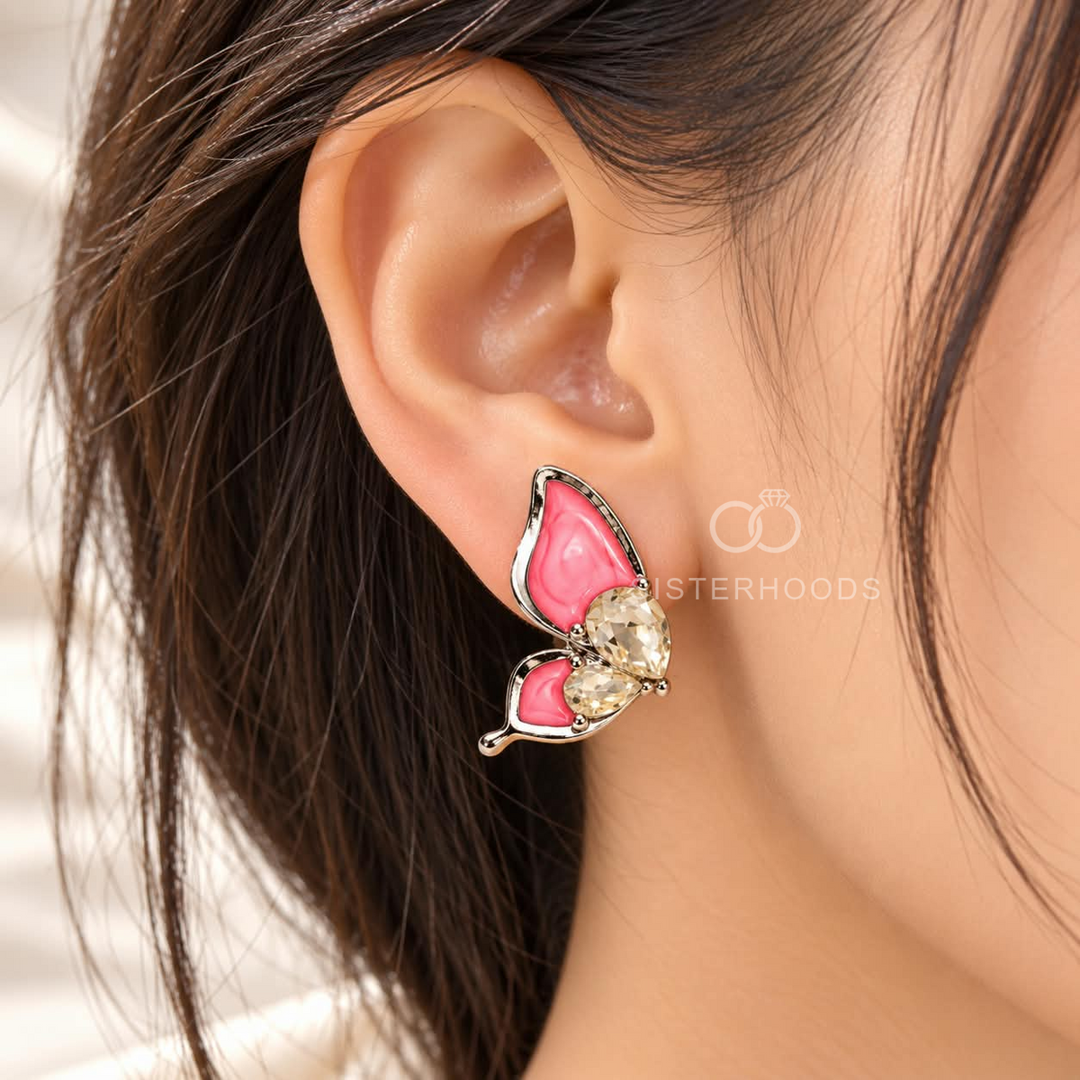 Pink butterfly stud earrings with faceted accents | SISTERHOODS-SHA256:8b3752ceac4bb544e11a50b7f4be3ce95f1bab4ec35112fd115d72faddbe6ba2