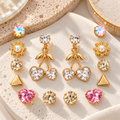 Gold-tone dangle earrings with faceted round accents, leafy details and twin heart charms | SISTERHOODS-SHA256:7c538d29ce8a68d70f833a54094268f24b20ec7c57a33d7c5897afa2efb2d3fc