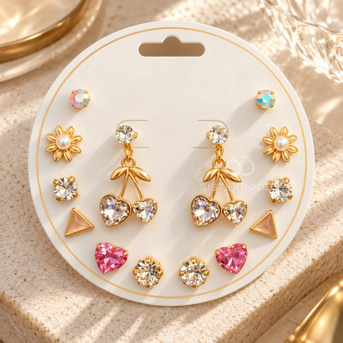 Gold-tone dangle earrings with faceted round accents, leafy details and twin heart charms | SISTERHOODS-SHA256:2c9254fd7847fb36aba15416cb9142c6b76dd6999f1cbd225a7ef803d0ff9b3e