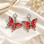 Red butterfly dangle earrings with clear faceted stud accents | SISTERHOODS-SHA256:6c5f0059bbcc7384ffcf6d977f0b63716f32e67a22c5e366aecf500cb6e5d81d