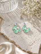 Mint-green fan-shaped dangle earrings with white detailing, pearl accents and clear faceted tops | SISTERHOODS-SHA256:142b30936baeb656e9d12bb689cd239d144e2dc5e3c2b660c09ffdf31fe19f55