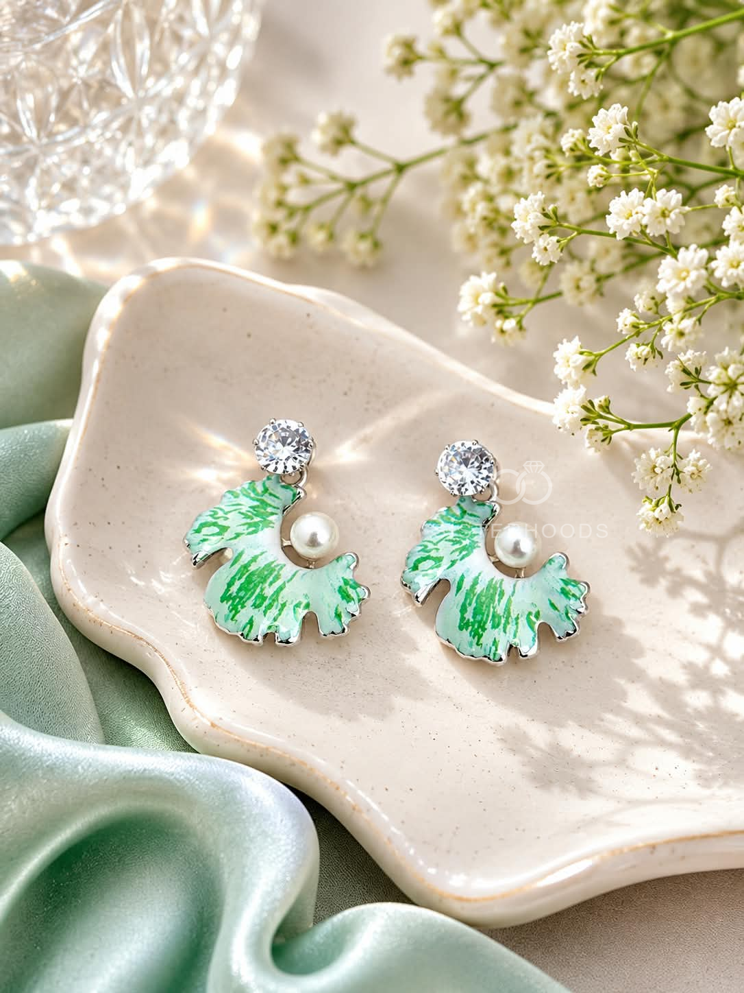 Mint-green fan-shaped dangle earrings with white detailing, pearl accents and clear faceted tops | SISTERHOODS-SHA256:959224276da40d6feccb0345e17b522fe1ff46cdb68ba26d481b1233dc987182