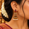 Gold-tone traditional jhumka earring with red teardrop accent, crystal details and white pearl fringe | SISTERHOODS-SHA256:c5c461a3b8771cfb0ddd027011d0003fd016198e64d701ed7c216ca9b527d211